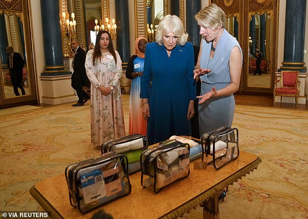 Queen Camilla looks at toiletry bags as she hosts a reception to honor those supporting survivors of sexual violence and the relaunch of the Wash Bags Project