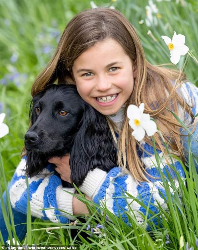 In another photo, she was pictured in a blue and white striped sweater from Boden as she snuggled up with the family's beloved black cocker spaniel Orla.
