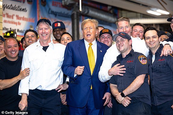 NEW YORK, NEW YORK - MAY 2: Republican presidential candidate, former US President, Donald Trump poses for photos with members of the FDNY Engine 2, Battalion 8 Fire Station on May 2, 2024 in New York City.  Trump delivered pizza to a fire station after a court appearance in his hush-money trial, which began with a hearing in which prosecutors argued that Judge Juan Merchan should again charge Trump with criminal contempt for violating a silence order.  Earlier this week, Trump was charged with contempt for nine violations of his April 1 order banning criticism of witnesses and jurors.  (Photo by Michael M. Santiago/Getty Images)