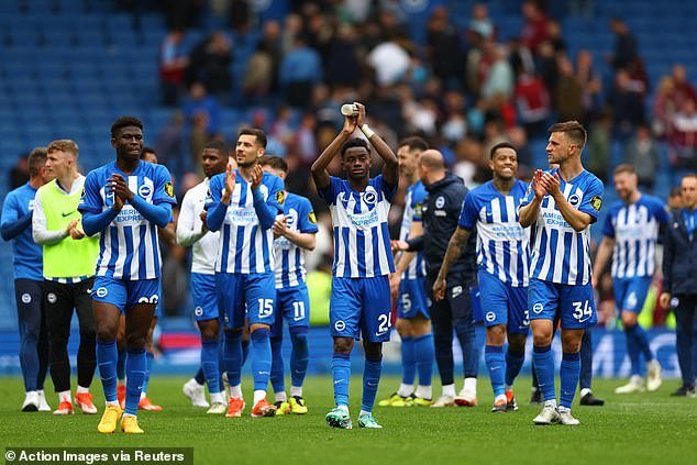 The Brighton players cheer on the club's supporters after securing victory against Aston Villa