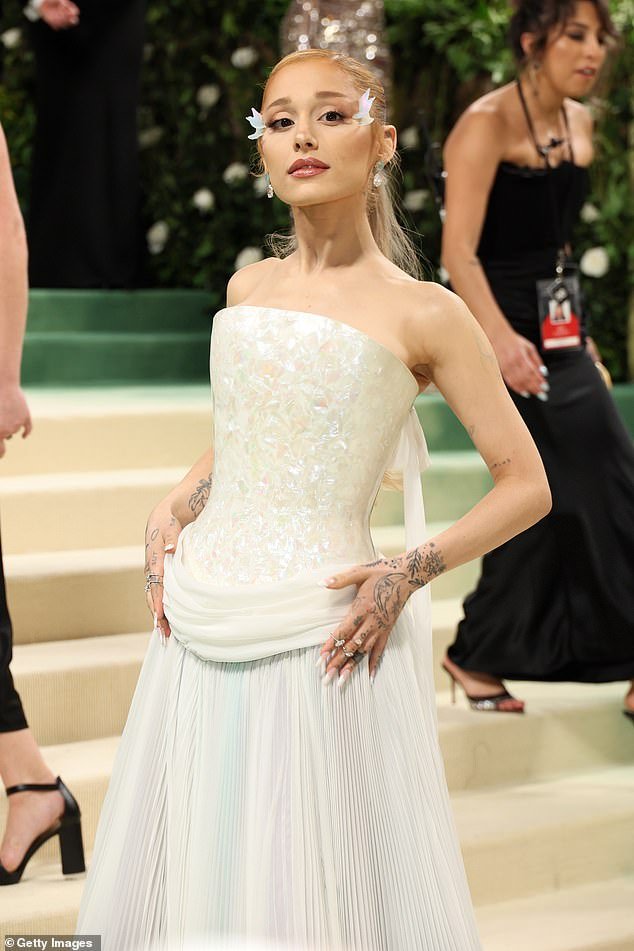 On the red carpet she wore an elegant white Loewe dress with a pleated skirt, but for the performance she donned a sheer green custom Maison Margiela Artisanal outfit by John Galliano.