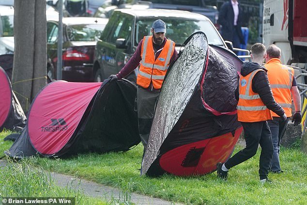 Crews towed pop-up tents from the area, which was closed to pedestrians and cyclists during the operation