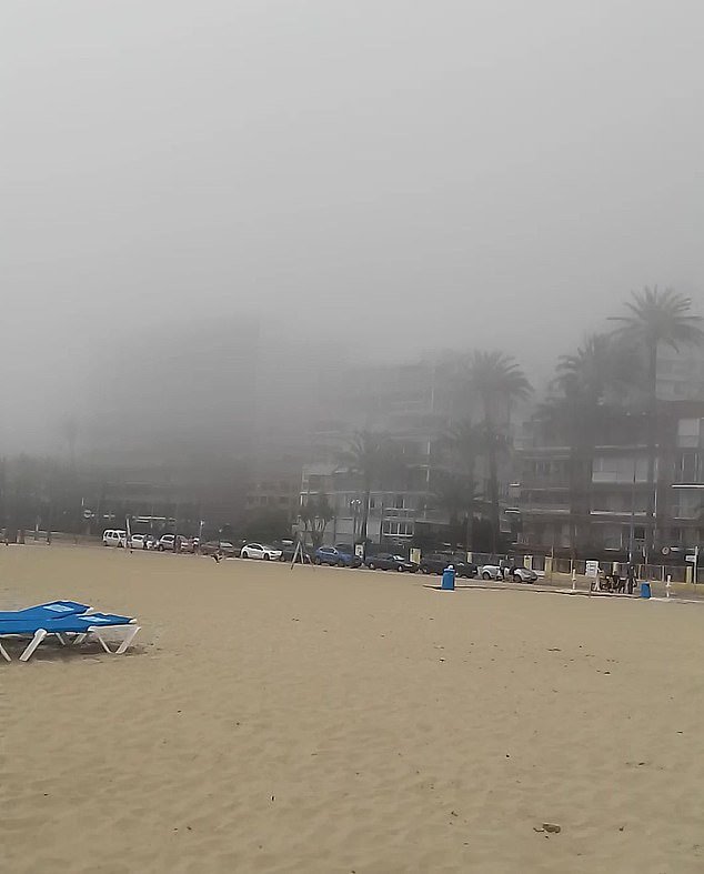 The 43-year-old assumed a fire had broken out in a nearby apartment but decided to stay on the beach to film the grisly sight, unlike most other holidaymakers who fled the strange phenomenon.  She later discovered that the fog was 'sea fog' - caused by a temperature difference on land and water