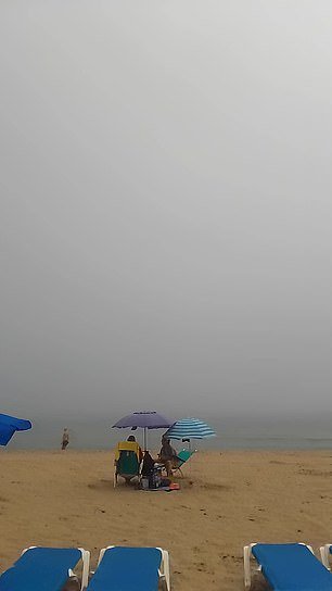 Holidaymakers were left stunned as a Benidorm beach disappeared into a thick fog - prompting Brits to rejoice at home as they basked in sunny 23 degree weather