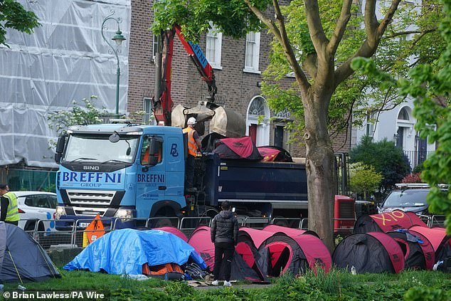 Tents were spray painted with an 'X' before being placed onto a truck by a 'grab' machine